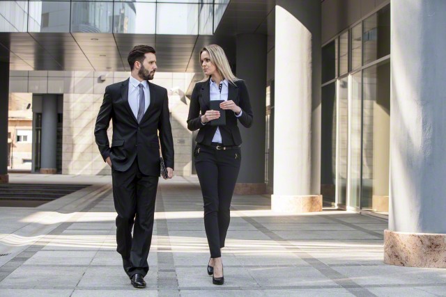 Business partners walking by office building